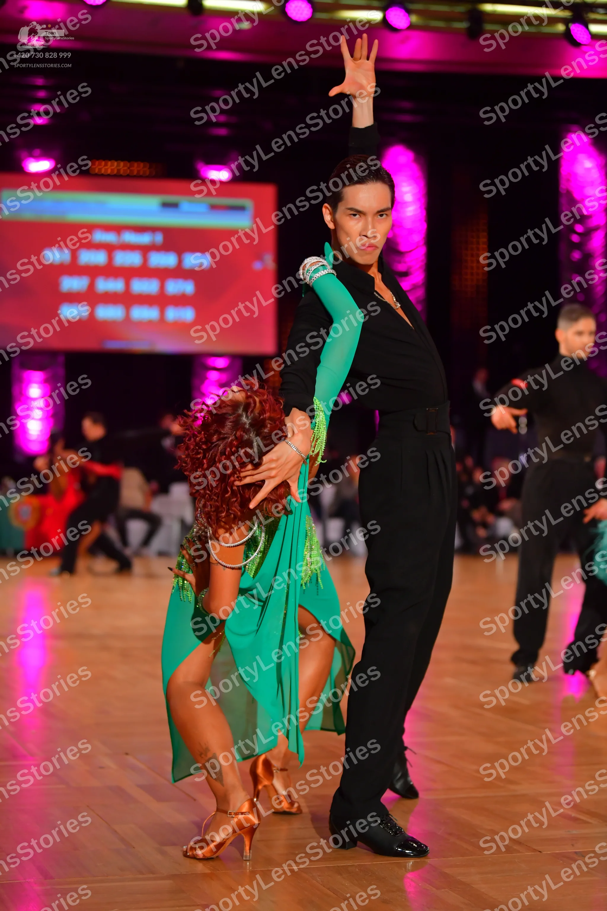 Dancesport competitor: Main female dancer: teal green latin dress with a flowing skirt