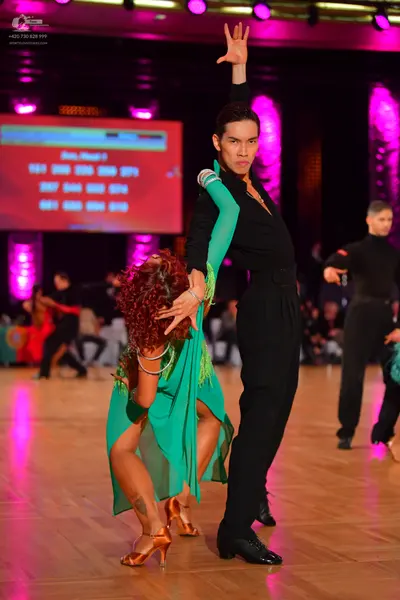 Dancesport competitor: Main female dancer: teal green latin dress with a flowing skirt