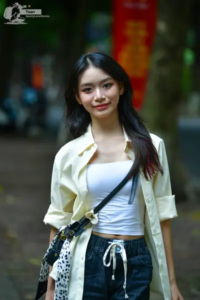 Dancesport competitor: Female dancer: off-white long-sleeved button-down shirt worn open over a white c
