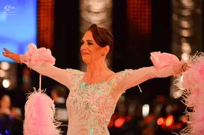 Dancesport competitor: Female dancer: light pink Latin dance dress with sequins, mint green embellishme