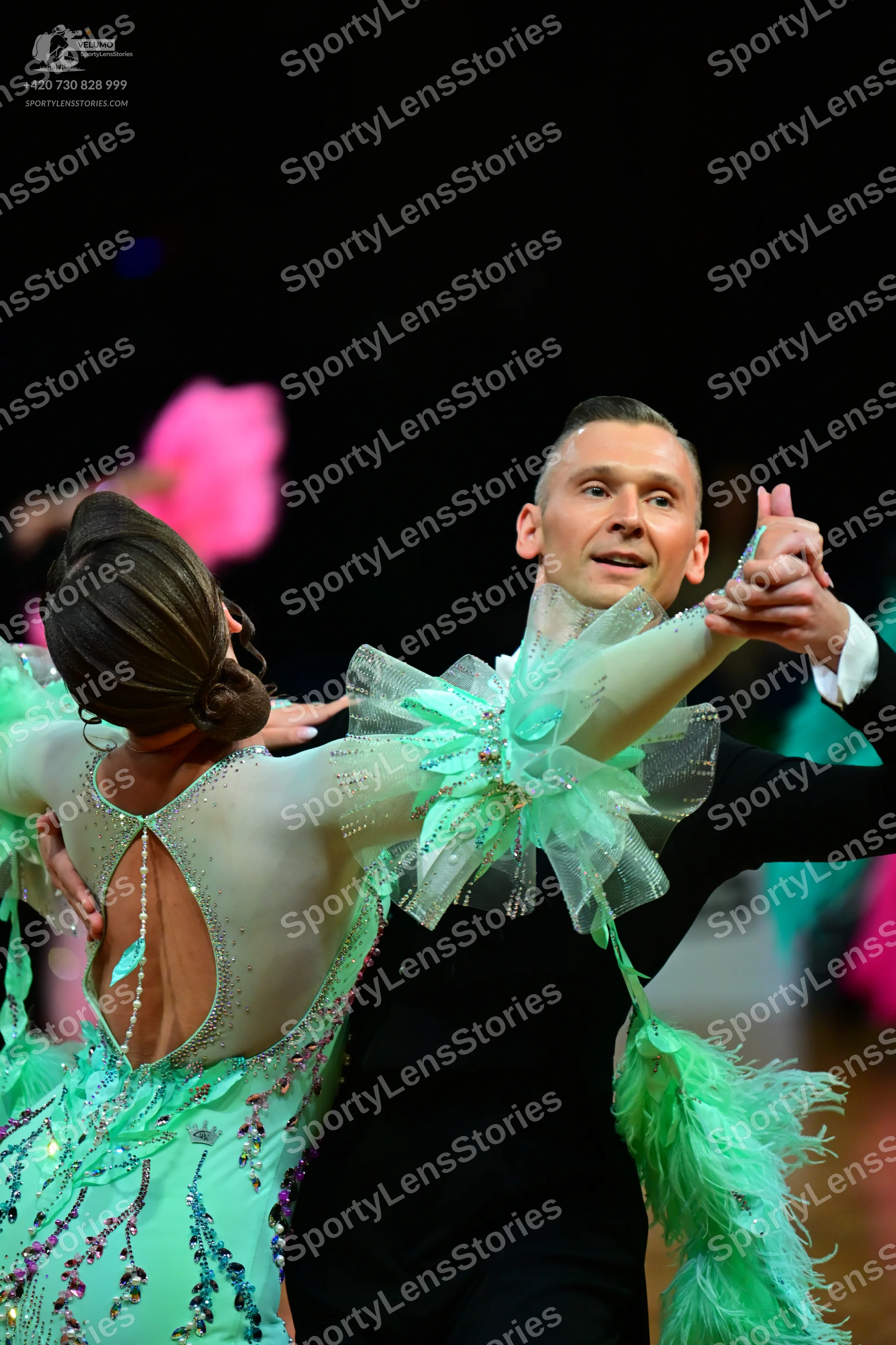 Dancesport competitor: Female dancer: mint green latin dress with sheer mesh panels, colorful sequins (