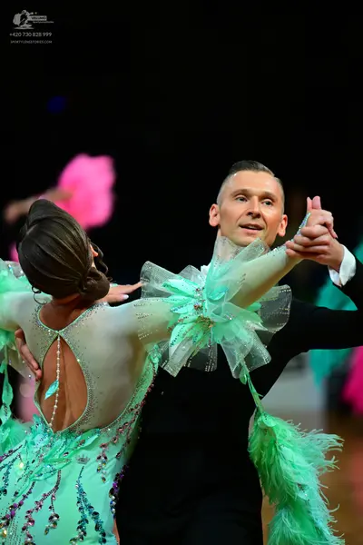 Dancesport competitor: Female dancer: mint green latin dress with sheer mesh panels, colorful sequins (