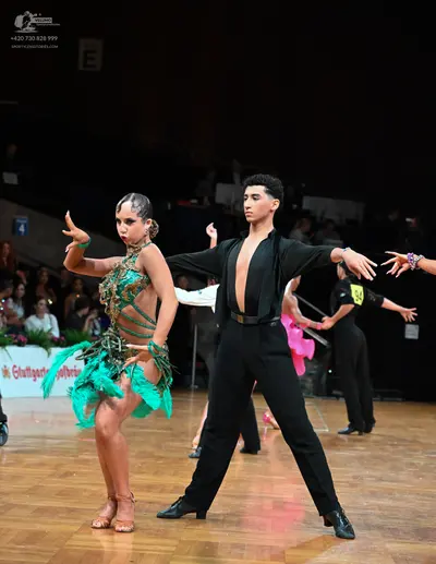 Dancesport competitor: Female dancer: green and gold Latin dress with sequins/beading and green fringe