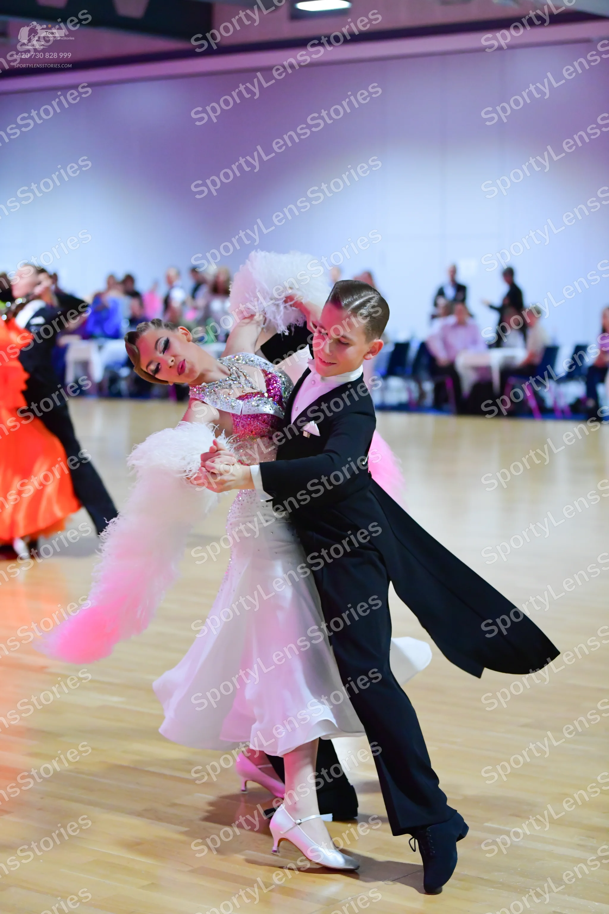 Dancesport competitor: Male dancer: black ballroom tailcoat with a white shirt and white pocket square