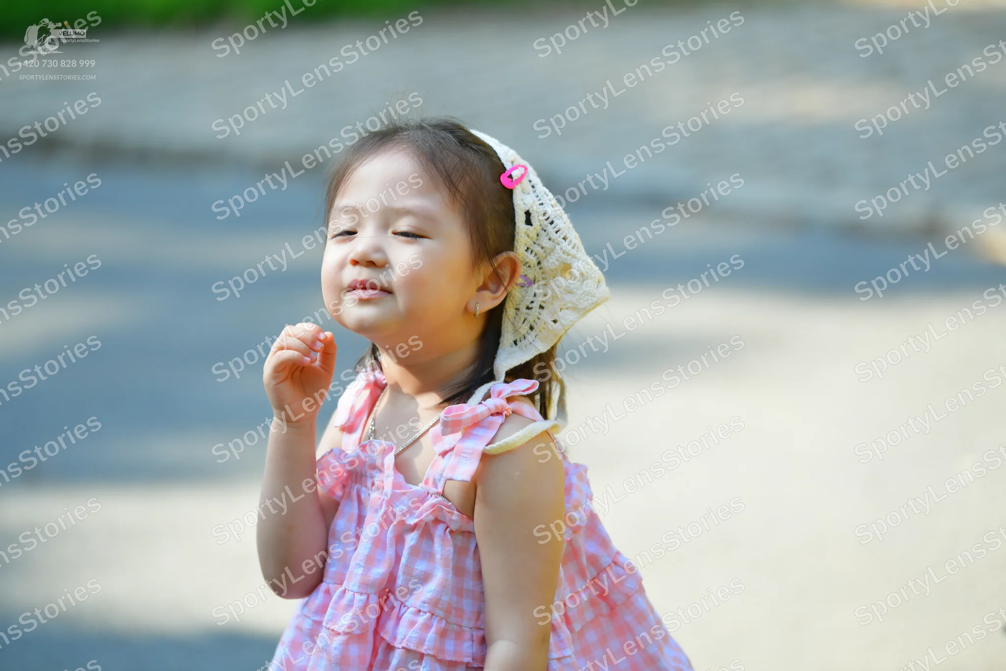 Dancesport competitor: Female dancer: pink and white gingham patterned sleeveless dress with ruffles