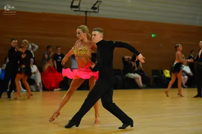 Dancesport competitor: Male dancer: black long-sleeved shirt and trousers