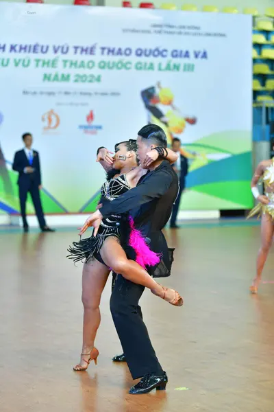 Dancesport competitor: ** Black tail suit
*   **Fabric:** Likely satin or a similar sheen, with sequins