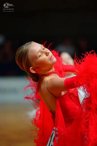 Dancesport competitor: Female dancer: red latin dress with red feathers and white/silver sequins
