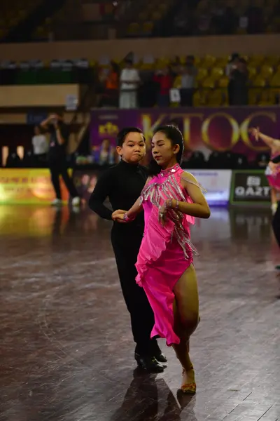 Dancesport competitor: Male dancer: black long-sleeved top and black trousers