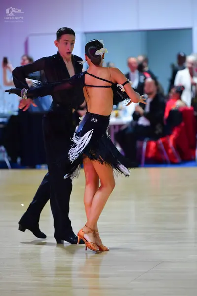 Dancesport competitor #42: Male dancer: black long-sleeved shirt and black trousers
