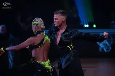 Dancesport competitor: Male dancer: black long-sleeved shirt with subtle sequins and black trousers