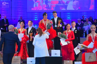 Dancesport competitor: Male dancers: black suits or tuxedos with white shirts and black bow ties