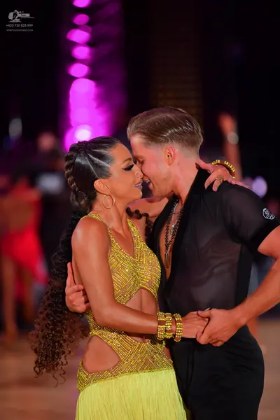Dancesport competitor: Female dancer: yellow latin dance costume with a sequined/beaded bodice featurin