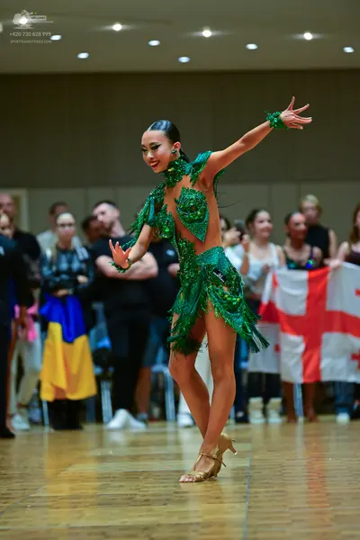 Dancesport competitor: Female dancer: green sequined latin dress