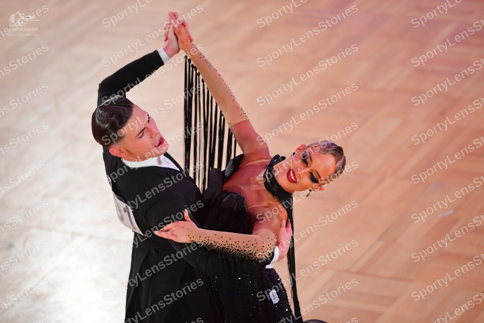 Dancesport competitor: Male dancer: black suit with a white waistcoat and white shirt