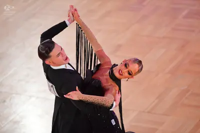 Dancesport competitor: Male dancer: black suit with a white waistcoat and white shirt