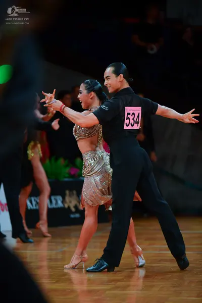 Dancesport competitor: Male dancer: black short-sleeved shirt and black trousers
