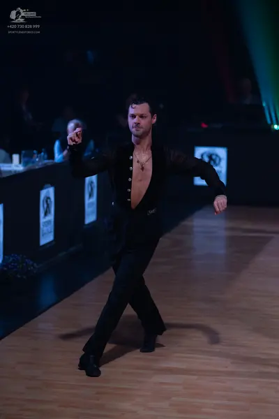 Dancesport competitor: Male dancer: black sheer shirt with buttons and black trousers