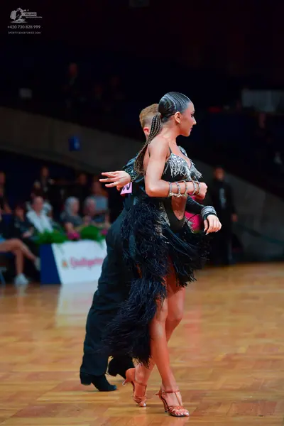 Dancesport competitor: Male dancer: black long-sleeved dance shirt and black trousers