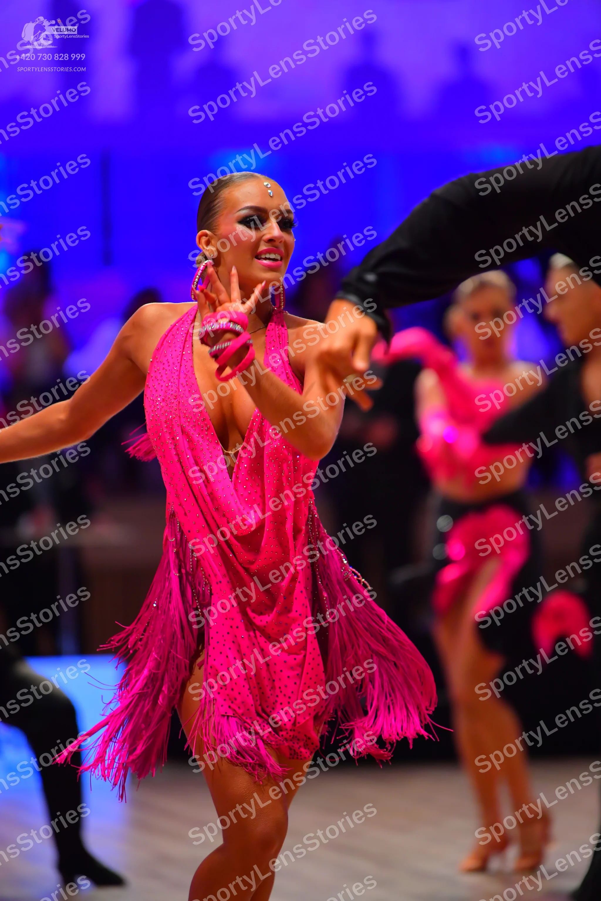 Dancesport competitor: Main female dancer: hot pink Latin dance dress with sequins and long fringe, fea