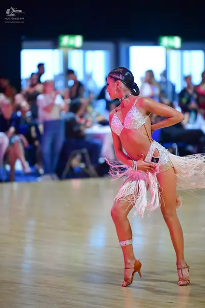 Dancesport competitor: Female dancer: white/silver Latin dance costume with rhinestone/sequin embellish
