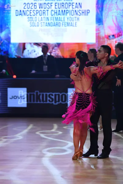 Dancesport competitor: Male dancer: black mesh-style shirt with subtle embellishments and black trouser
