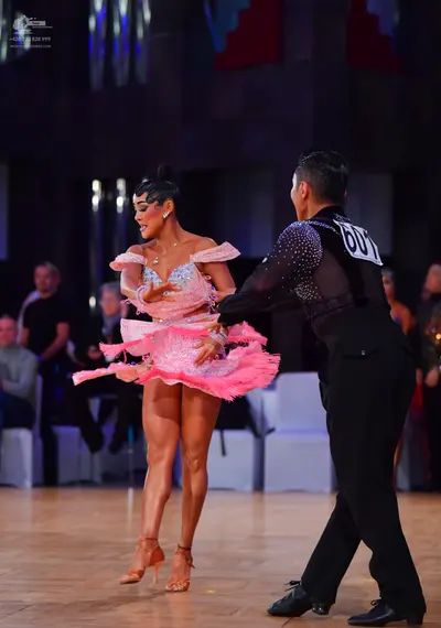 Dancesport competitor #601: Male dancer: black long-sleeved shirt with sequins on the shoulder and black tro
