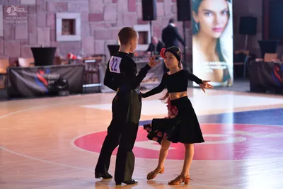 Dancesport competitor #22: Male dancer: black long-sleeved shirt and black trousers