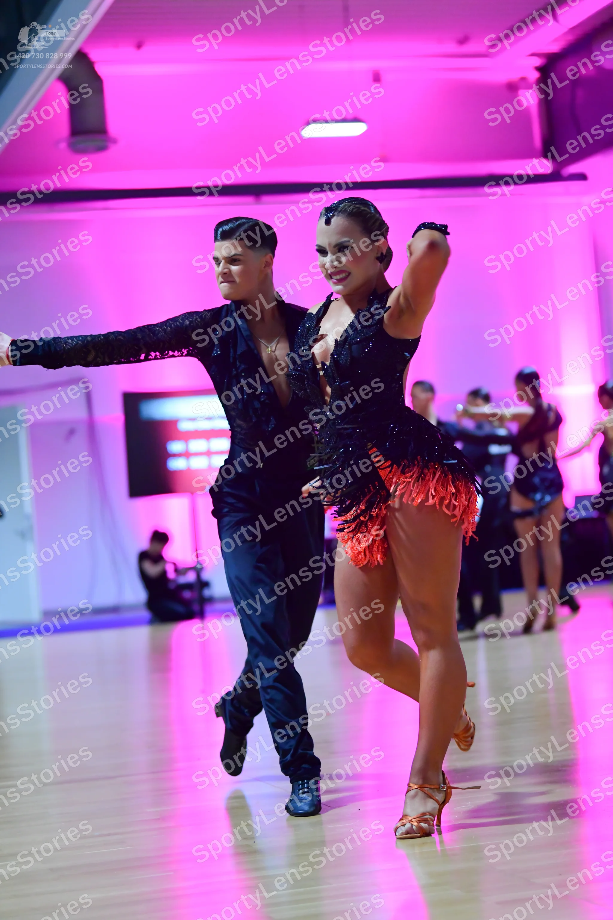 Dancesport competitor: Male dancer: black long-sleeved shirt and trousers with shimmering details