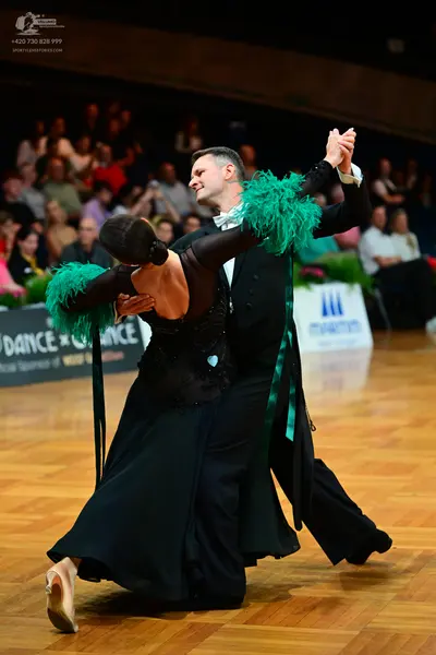 Dancesport competitor: Male dancer: black suit with a white shirt and a white bow tie