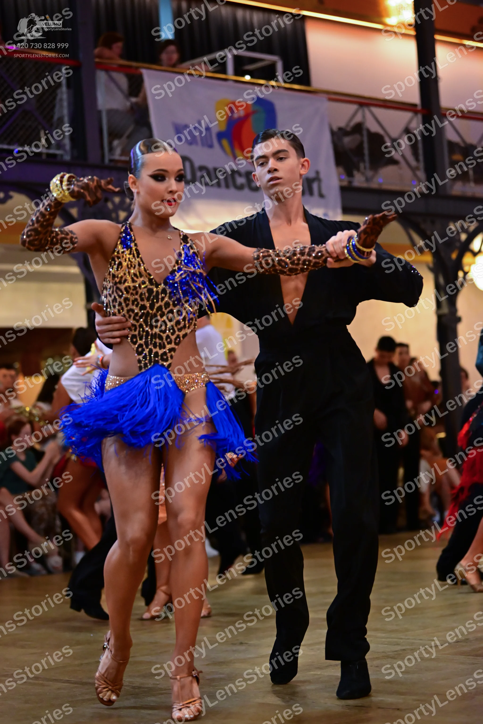 Dancesport competitor: Male dancer: black long-sleeved shirt with a deep V-neckline and leopard print s