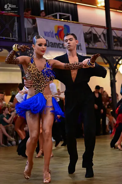 Dancesport competitor: Male dancer: black long-sleeved shirt with a deep V-neckline and leopard print s