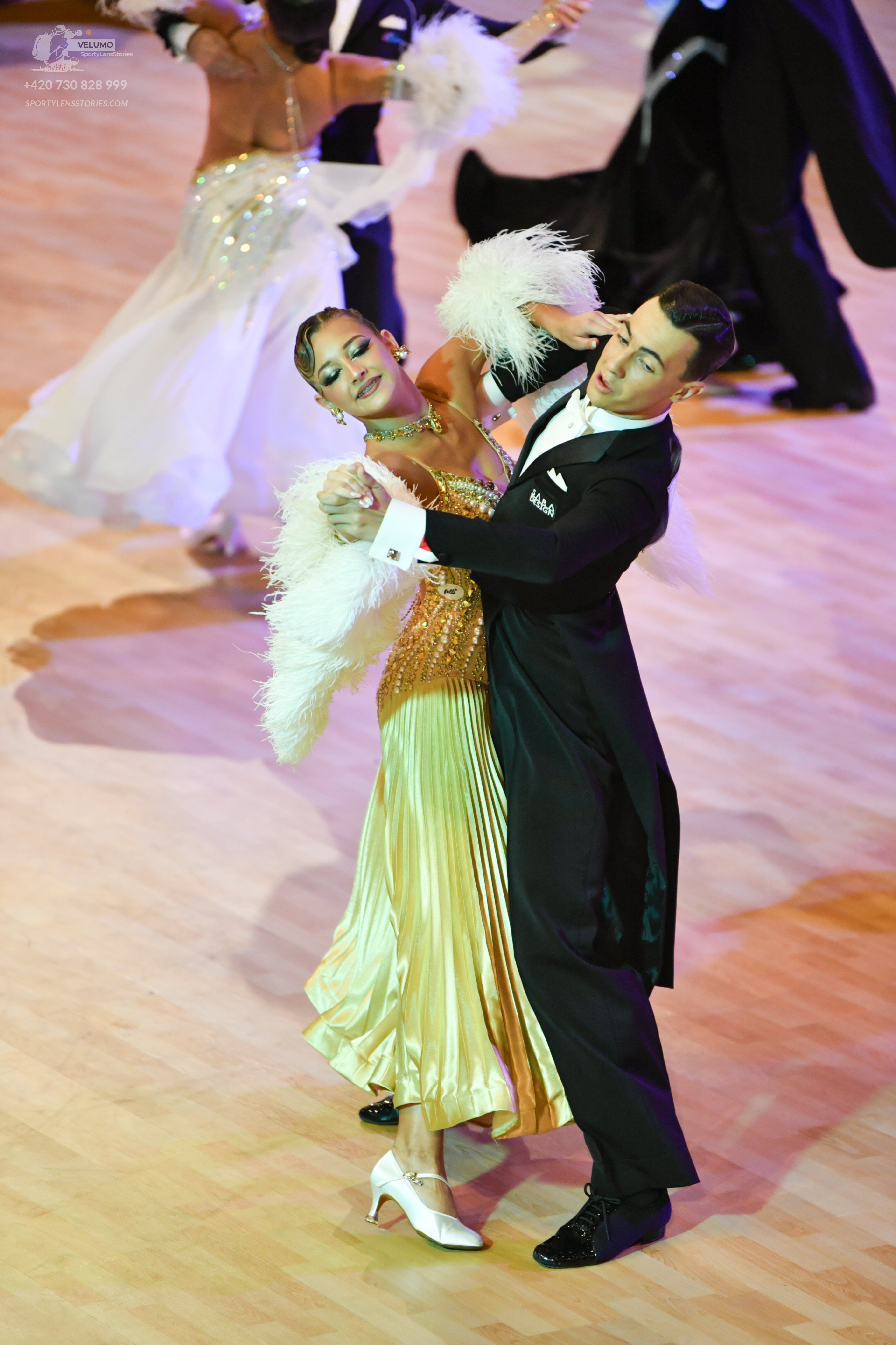 Dancesport competitor: ** Black tail suit with white sequin lapels and cuffs