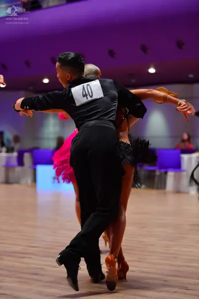 Dancesport competitor: Male dancer: black long-sleeved shirt and black trousers
