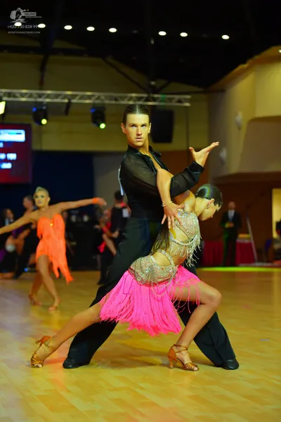 Dancesport competitor: Male dancer: black long-sleeved shirt and black trousers