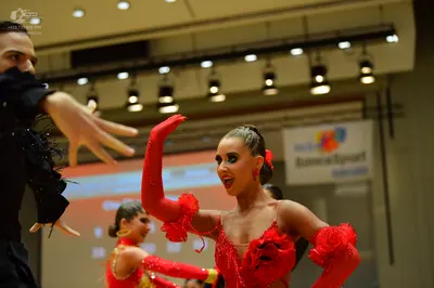 Dancesport competitor: Male dancer: black long-sleeved top with subtle black embellishments