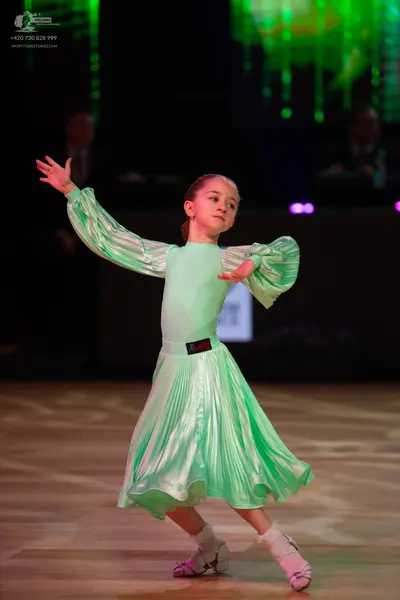 Dancesport competitor: Female dancer: light mint green satin dress with long puffed sleeves and a pleat