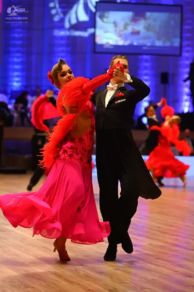 Dancesport competitor: Male dancer: black suit with a white shirt and white bow tie
