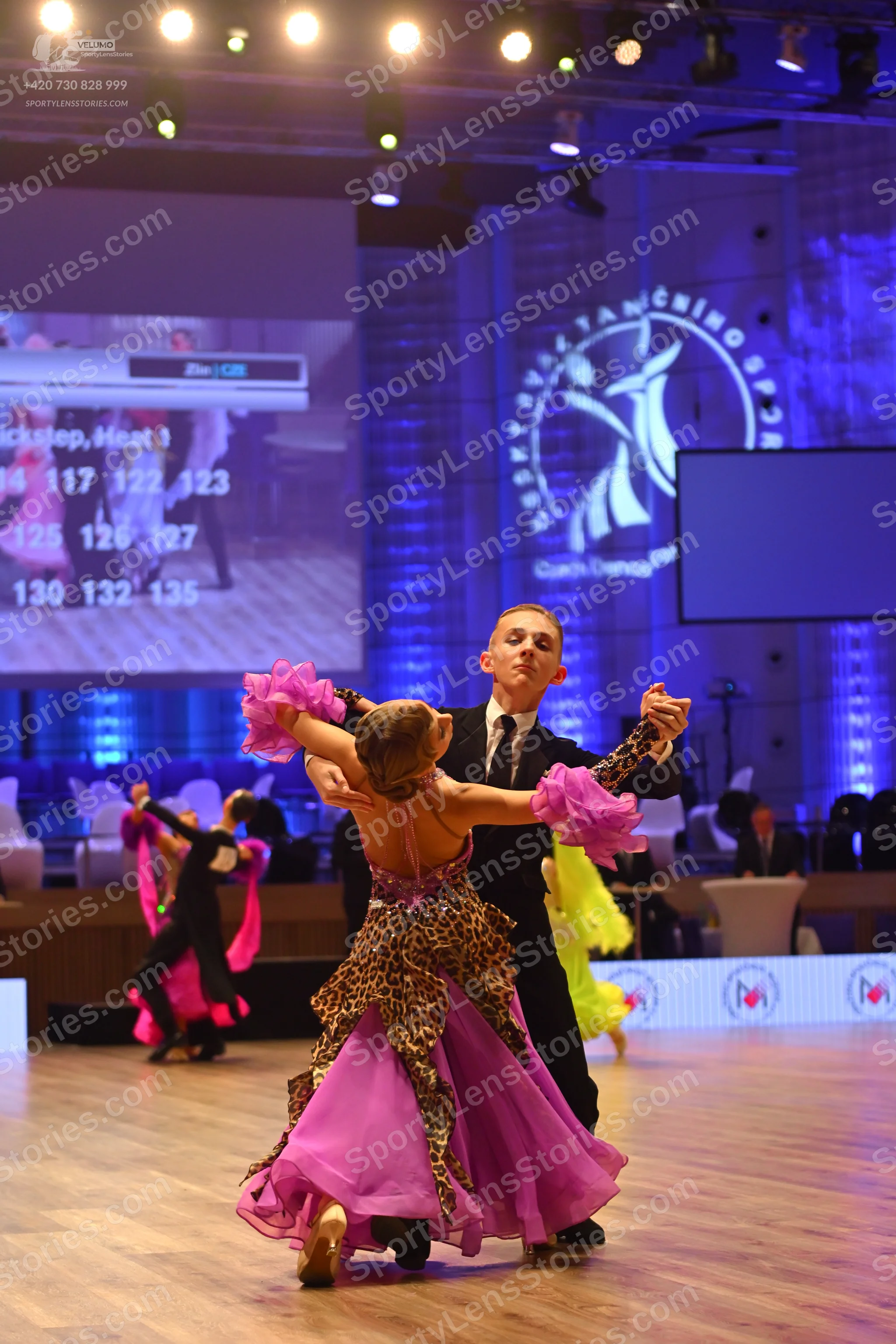 Dancesport competitor: Male dancer: black suit, white shirt, and black tie