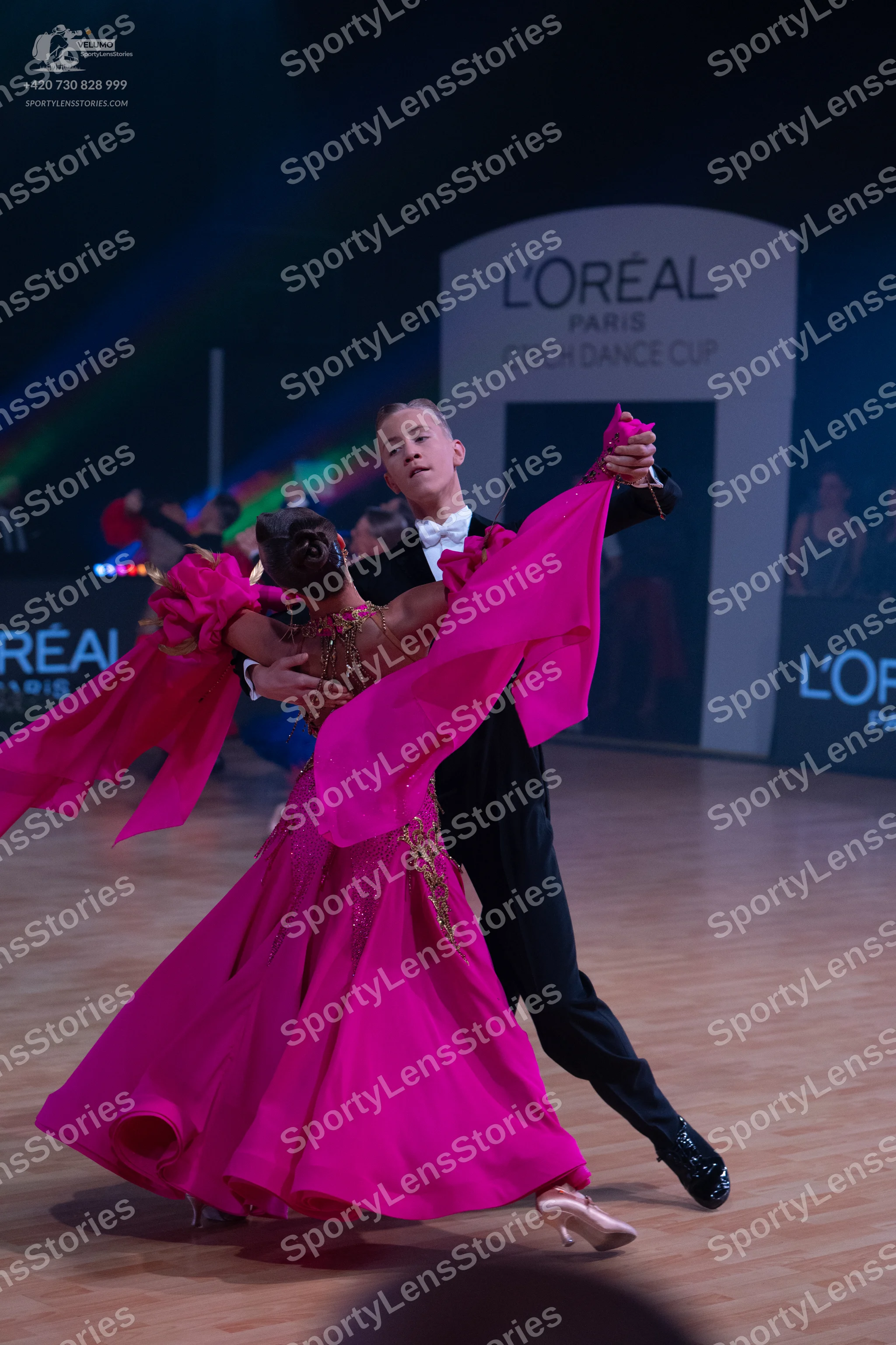 Dancesport competitor: Male dancer: black suit with a white shirt and white bow tie