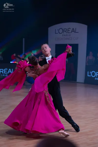 Dancesport competitor: Male dancer: black suit with a white shirt and white bow tie