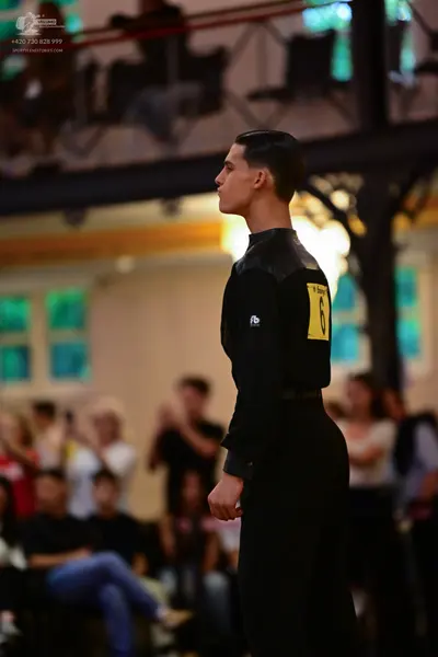 Dancesport competitor: Male dancer: black long-sleeved top and black trousers