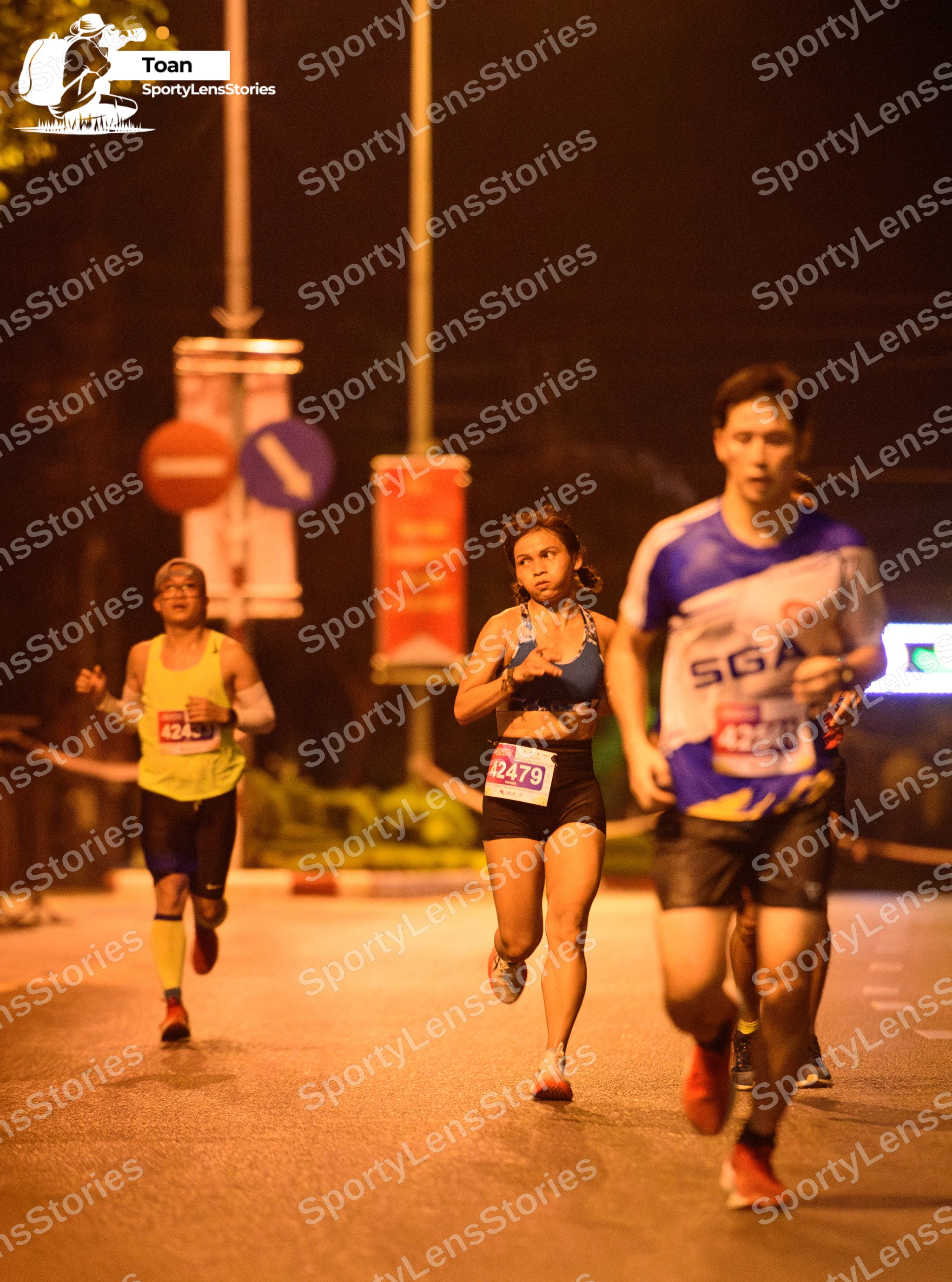 Marathon runner #424, #4279: Runner 1: lime green jersey, black shorts, black and orange socks, orange shoes