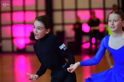 Dancesport competitor: Male dancer: black long-sleeved top and black trousers