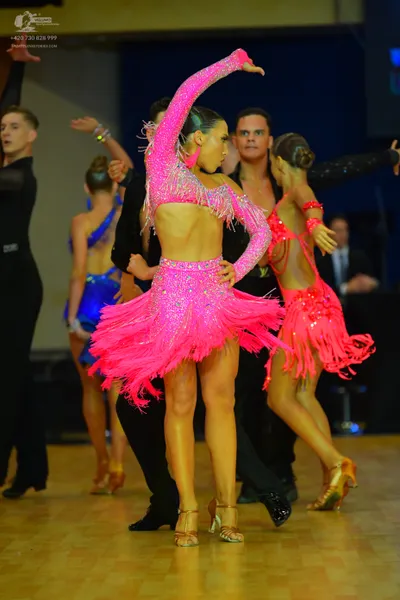 Dancesport competitor: Male dancer (far left): black long-sleeved dance top