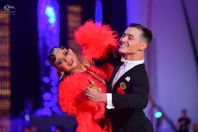 Dancesport competitor: Male dancer: black suit with a white shirt