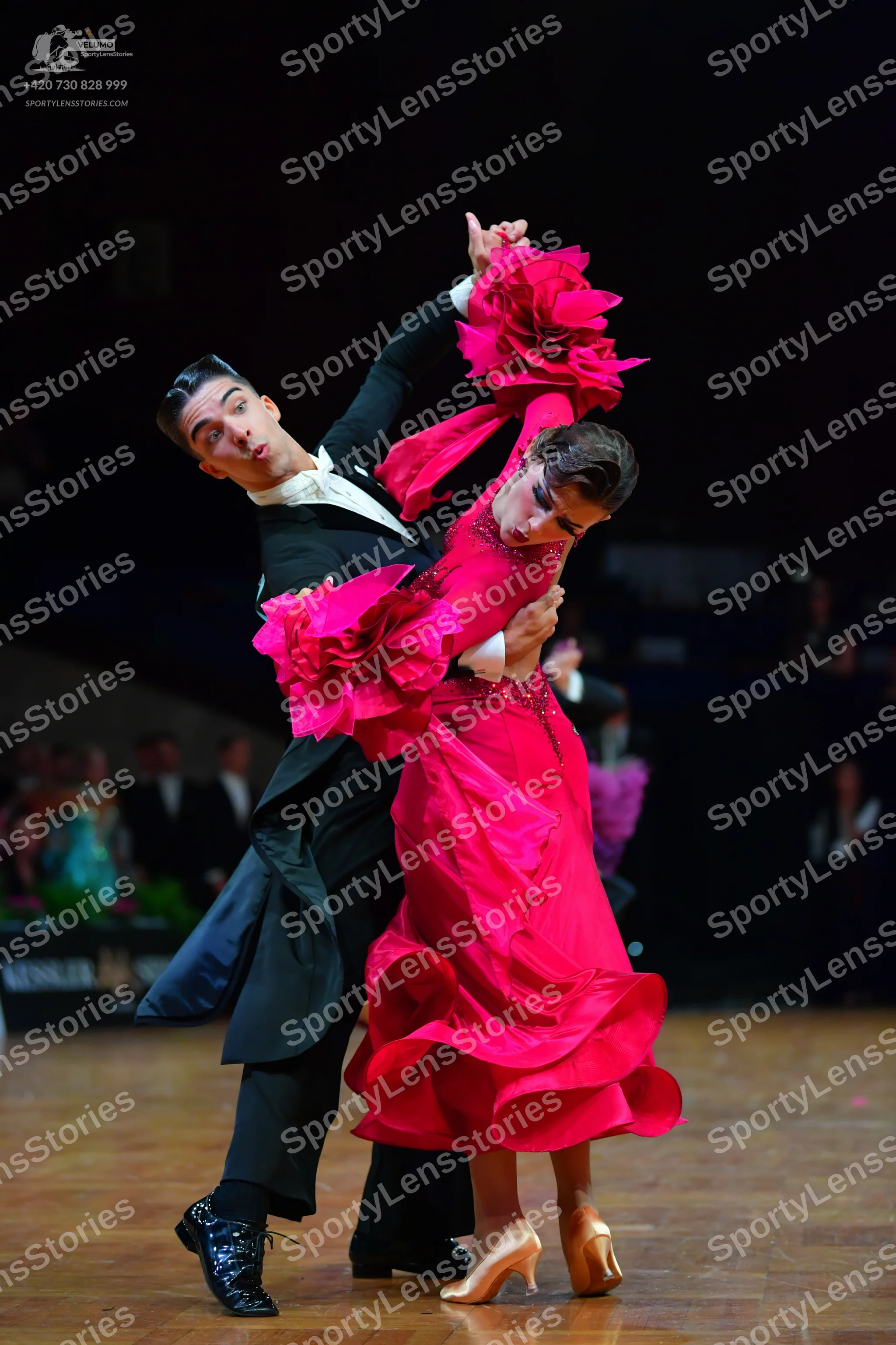 Dancesport competitor: Male dancer: black ballroom tailcoat, white shirt, black trousers, and black dan