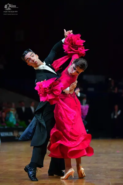 Dancesport competitor: Male dancer: black ballroom tailcoat, white shirt, black trousers, and black dan