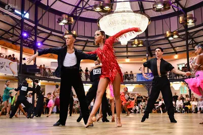 Dancesport competitor #142, #149: Male dancer (left): black suit jacket, white shirt, and black trousers