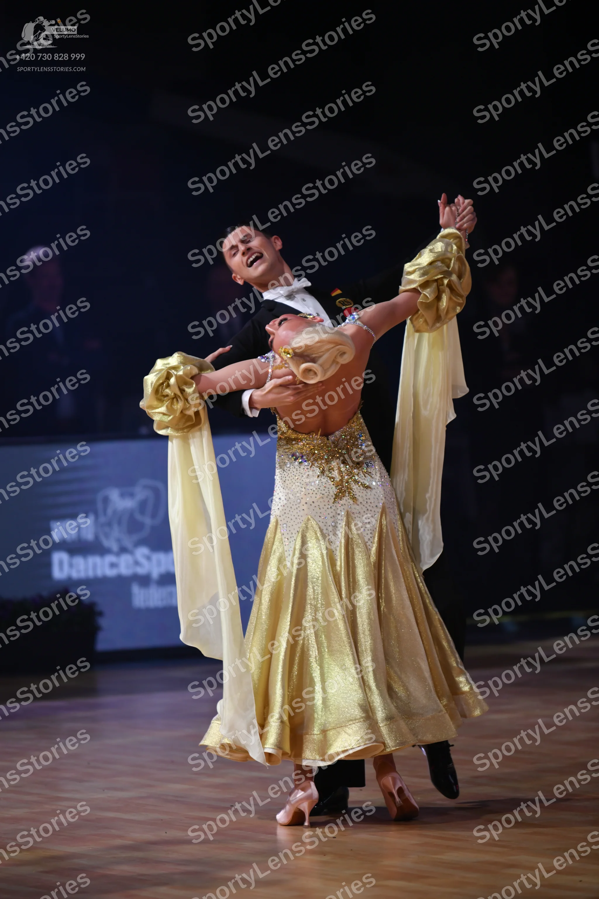 Dancesport competitor: Male dancer: black suit with a white shirt and white bowtie